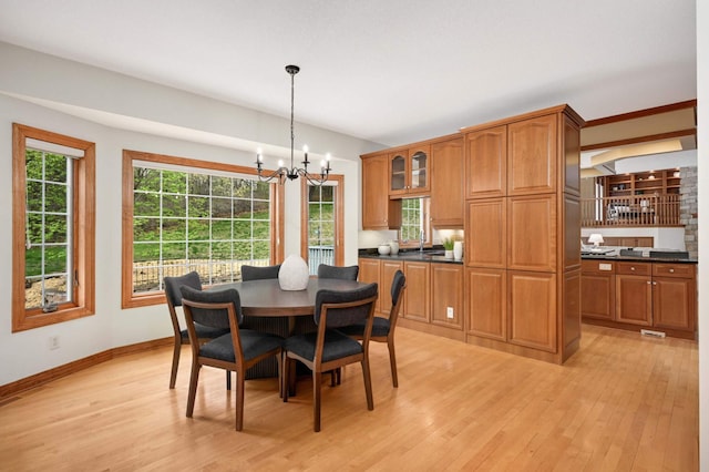 6507 Orchard Ridge Trl, Woodbury, MN 55129 - dining area with light wood finished floors and a chandelier