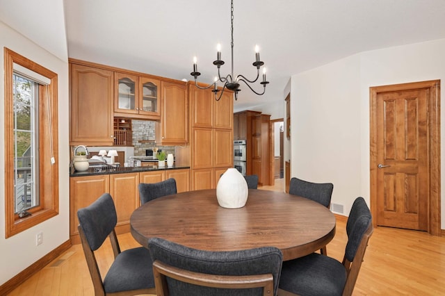 6507 Orchard Ridge Trl, Woodbury, MN 55129 - dining room featuring a chandelier and light wood finished floors