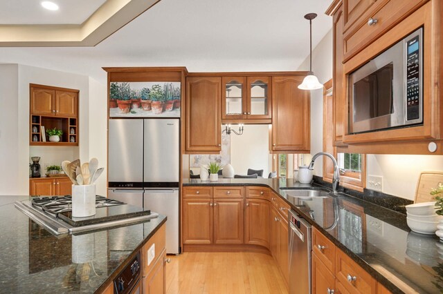 6507 Orchard Ridge Trl, Woodbury, MN 55129 - kitchen featuring stainless steel appliances, light wood finished floors, brown cabinetry, pendant lighting, and recessed lighting