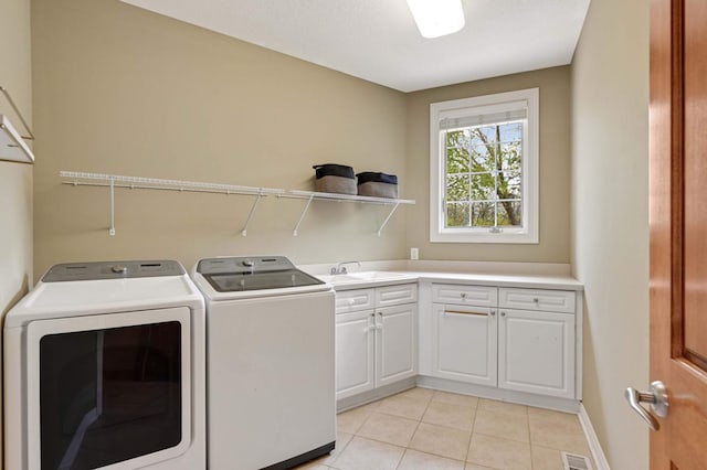 6507 Orchard Ridge Trl, Woodbury, MN 55129 - laundry area with cabinet space, washing machine and dryer, and light tile patterned floors
