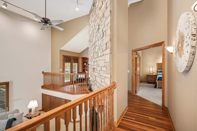 6507 Orchard Ridge Trl, Woodbury, MN 55129 - hall with high vaulted ceiling, wood finished floors, rail lighting, and an upstairs landing