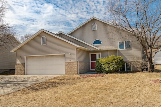 2625 Westview Ln NW, Rochester, MN 55901 - view of front of house featuring driveway, brick siding, a garage, and a front lawn