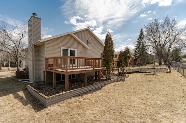 2625 Westview Ln NW, Rochester, MN 55901 - rear view of property with a chimney, fence, and a wooden deck