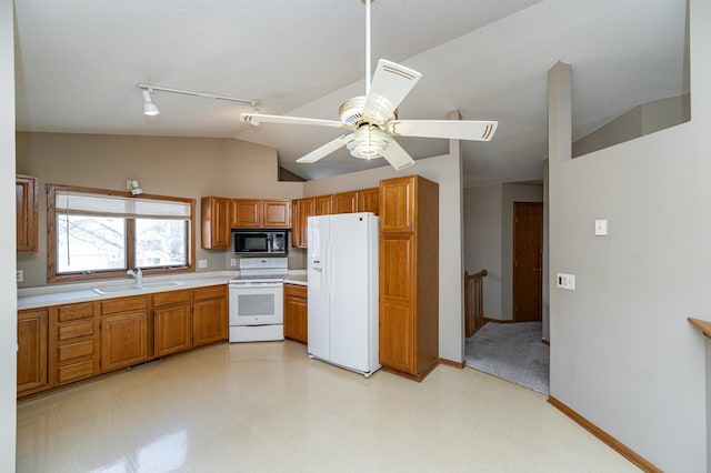 2625 Westview Ln NW, Rochester, MN 55901 - kitchen with light countertops, white appliances, a sink, brown cabinets, and light floors