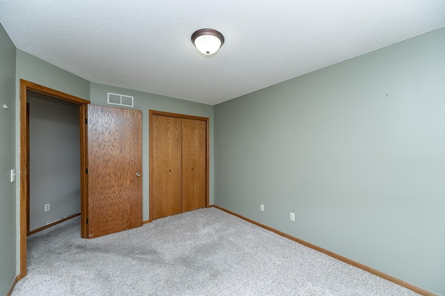 2625 Westview Ln NW, Rochester, MN 55901 - unfurnished bedroom with baseboards, visible vents, carpet flooring, and a textured ceiling