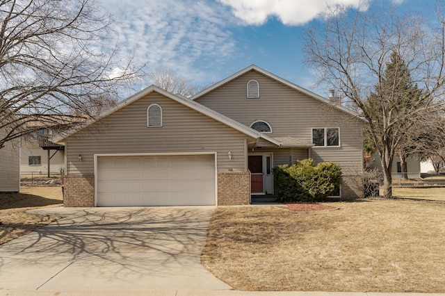 2625 Westview Ln NW, Rochester, MN 55901 - view of front facade with driveway, brick siding, and a garage