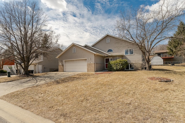 2625 Westview Ln NW, Rochester, MN 55901 - view of front of house featuring brick siding, a front yard, driveway, and a garage