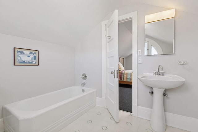2924 Farwell Ave, Minneapolis, MN 55411 - bathroom with a bath, vaulted ceiling, ensuite bath, baseboards, and tile patterned flooring