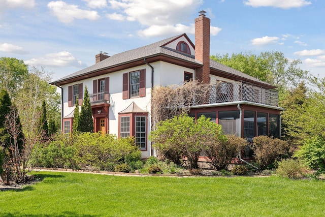 2924 Farwell Ave, Minneapolis, MN 55411 - view of front of home featuring a balcony, a chimney, stucco siding, and a front yard