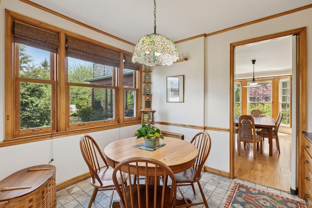2924 Farwell Ave, Minneapolis, MN 55411 - dining room featuring healthy amount of natural light, crown molding, baseboards, and a chandelier