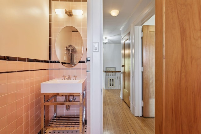 2924 Farwell Ave, Minneapolis, MN 55411 - bathroom with tile walls, wood finished floors, and a sink