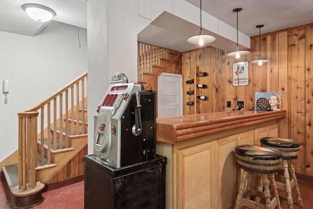 2924 Farwell Ave, Minneapolis, MN 55411 - indoor dry bar featuring stairs, wood walls, and pendant lighting