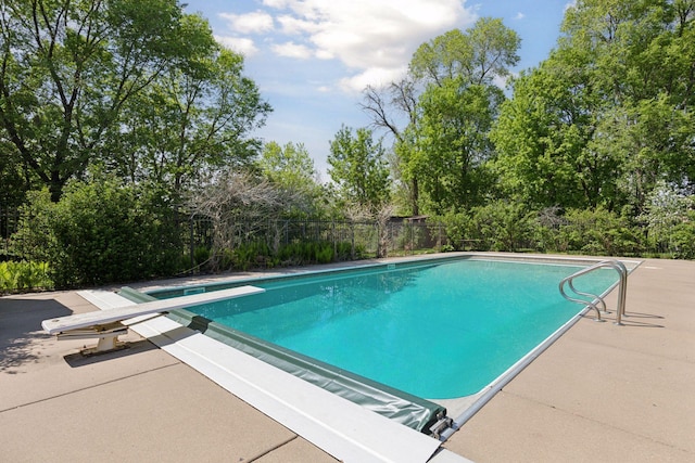 2924 Farwell Ave, Minneapolis, MN 55411 - swimming pool with a diving board, a patio, and view of scattered trees