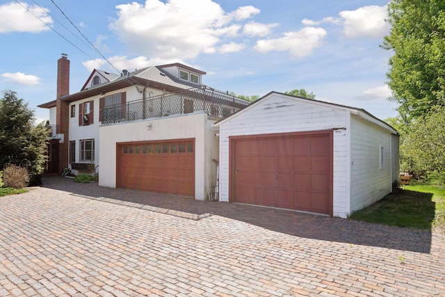 2924 Farwell Ave, Minneapolis, MN 55411 - view of front facade featuring a balcony, stucco siding, and a chimney