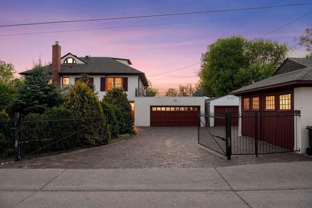 2924 Farwell Ave, Minneapolis, MN 55411 - view of front of home with a garage, a chimney, stucco siding, and an outdoor structure
