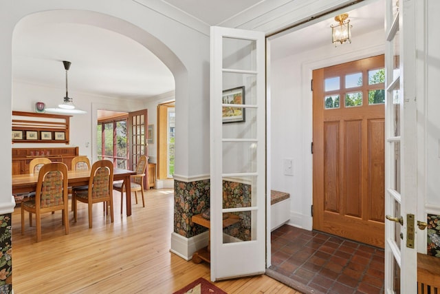 2924 Farwell Ave, Minneapolis, MN 55411 - foyer entrance featuring arched walkways, crown molding, plenty of natural light, french doors, and baseboards
