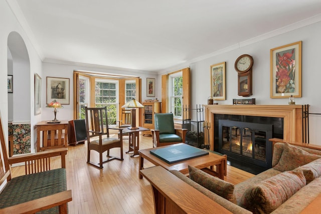 2924 Farwell Ave, Minneapolis, MN 55411 - living room featuring a fireplace with flush hearth, plenty of natural light, ornamental molding, arched walkways, and hardwood / wood-style floors