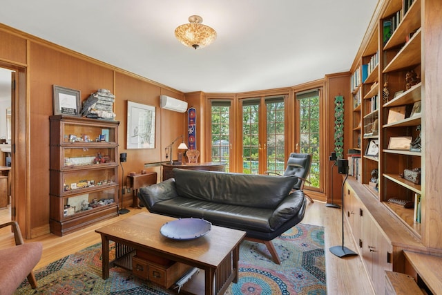 2924 Farwell Ave, Minneapolis, MN 55411 - living room featuring a wall mounted AC, light wood-style flooring, and wood walls