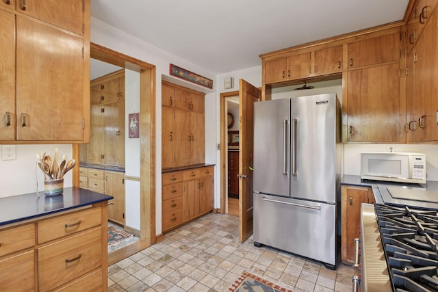 2924 Farwell Ave, Minneapolis, MN 55411 - kitchen featuring high end fridge, white microwave, dark countertops, stovetop, and brown cabinetry