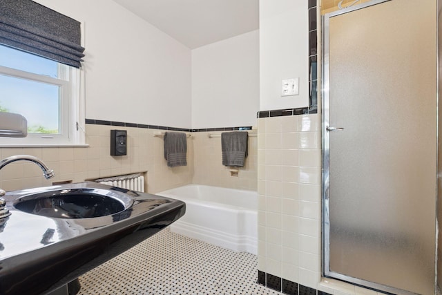 2924 Farwell Ave, Minneapolis, MN 55411 - full bath featuring a bath, tile walls, a stall shower, wainscoting, and a sink