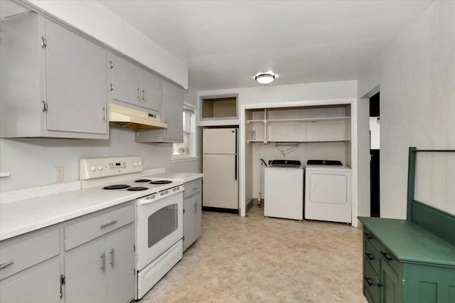 kitchen featuring white appliances, under cabinet range hood, washing machine and dryer, open shelves, and light floors