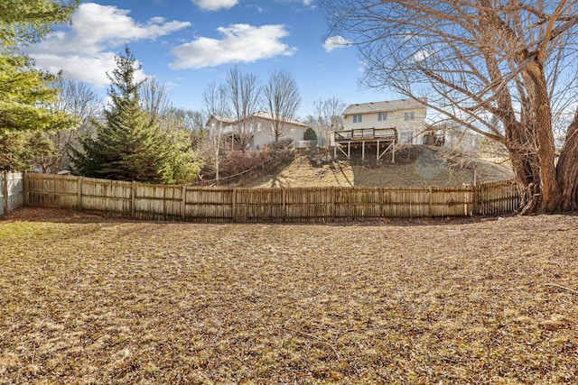 view of yard featuring a deck and fence