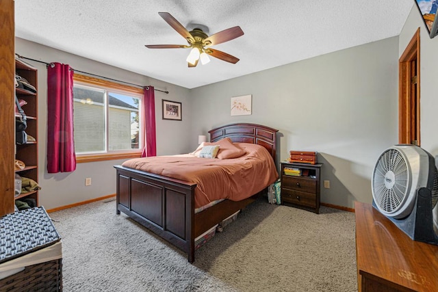carpeted bedroom featuring baseboards, a textured ceiling, and ceiling fan