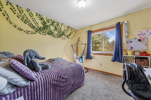 carpeted bedroom featuring visible vents, baseboards, and a textured ceiling