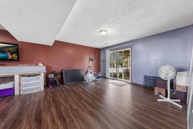 interior space featuring baseboards, wood finished floors, and a textured ceiling