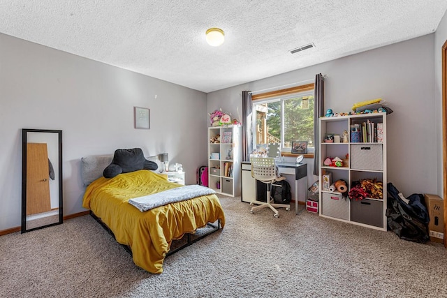 carpeted bedroom with a textured ceiling, baseboards, and visible vents