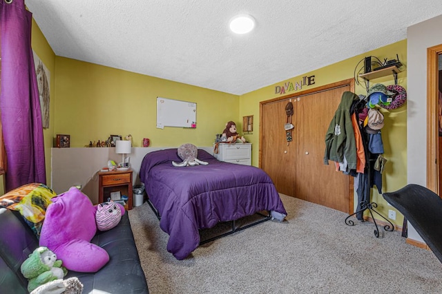 carpeted bedroom featuring a closet and a textured ceiling