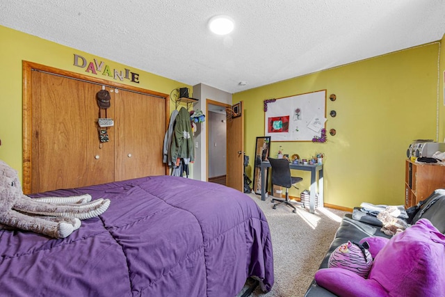 carpeted bedroom with a closet, a textured ceiling, and baseboards