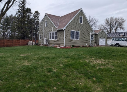 view of property exterior featuring a yard and fence