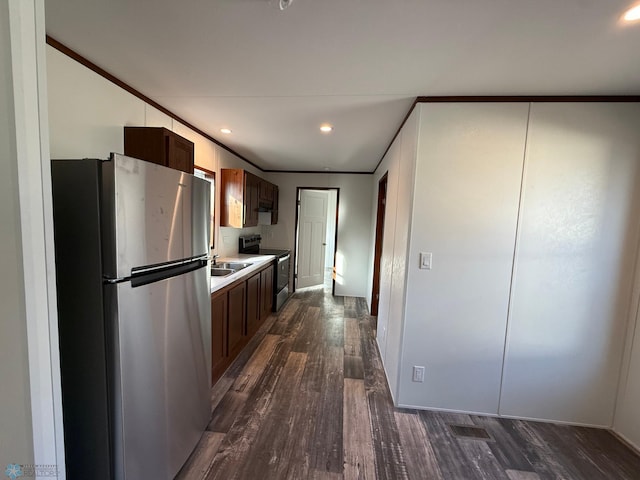 1224 15th Ave N # 45, Moorhead, MN 56560 - kitchen featuring appliances with stainless steel finishes, dark wood finished floors, light countertops, recessed lighting, and ornamental molding