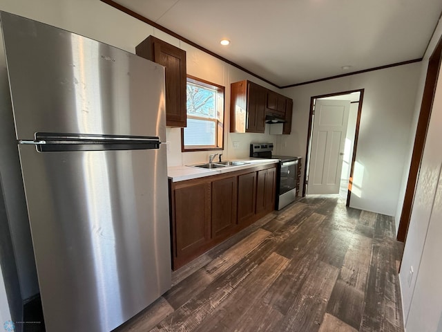 1224 15th Ave N # 45, Moorhead, MN 56560 - kitchen with stainless steel appliances, a sink, crown molding, dark wood-style flooring, and under cabinet range hood