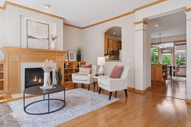 13 4th Ave N Unit 106, Minneapolis, MN 55401 - living area featuring light wood-style flooring, recessed lighting, a high end fireplace, baseboards, and crown molding
