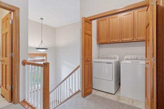 13 4th Ave N Unit 106, Minneapolis, MN 55401 - laundry room with washing machine and clothes dryer, cabinet space, and light tile patterned floors