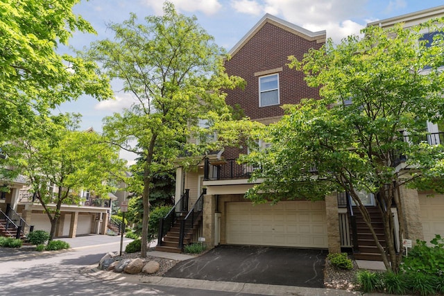 13 4th Ave N Unit 106, Minneapolis, MN 55401 - view of property with stairs, brick siding, and driveway