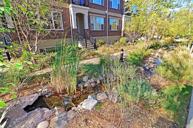 13 4th Ave N Unit 106, Minneapolis, MN 55401 - entrance to property featuring brick siding and a small pond