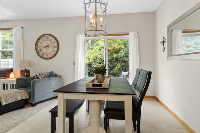 5633 200th St W Unit 1102, Farmington, MN 55024 - dining room featuring a chandelier, baseboards, and light tile patterned floors