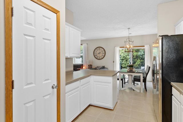 5633 200th St W Unit 1102, Farmington, MN 55024 - kitchen with freestanding refrigerator, a peninsula, light tile patterned flooring, light countertops, and white cabinets
