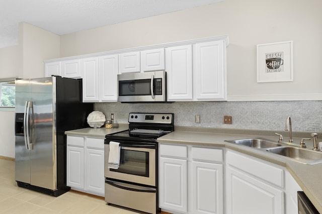 5633 200th St W Unit 1102, Farmington, MN 55024 - kitchen with stainless steel appliances, a sink, light countertops, white cabinets, and light tile patterned floors