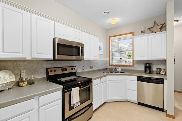 5633 200th St W Unit 1102, Farmington, MN 55024 - kitchen with stainless steel appliances, a sink, white cabinetry, light countertops, and a textured ceiling