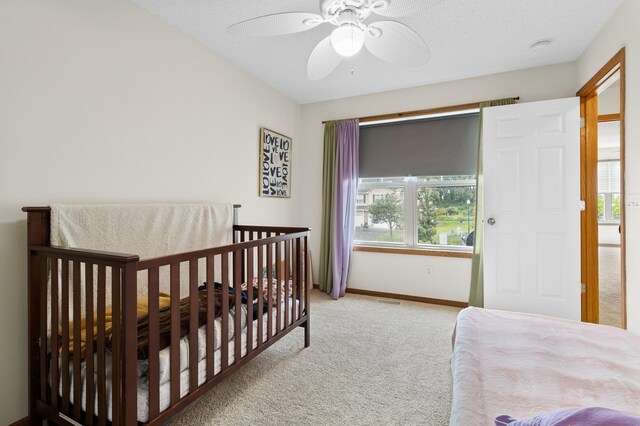 5633 200th St W Unit 1102, Farmington, MN 55024 - carpeted bedroom with multiple windows, ceiling fan, baseboards, and a crib