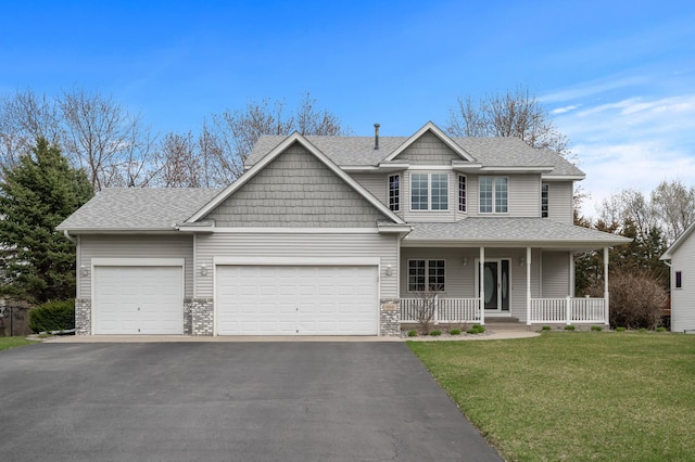 view of front of home with driveway, a shingled roof, covered porch, a front yard, and a garage