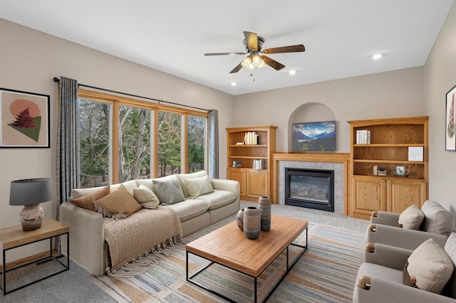 living room with recessed lighting, ceiling fan, a fireplace with flush hearth, and light colored carpet