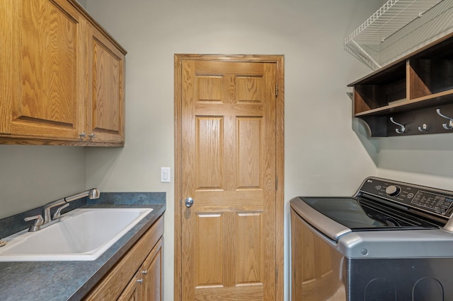 laundry area with a sink, cabinet space, and washer / clothes dryer