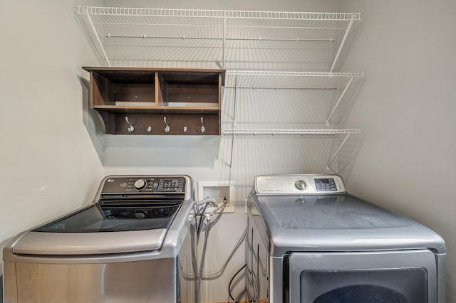 clothes washing area with washer and dryer and laundry area
