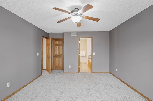 unfurnished bedroom with baseboards, visible vents, and a textured ceiling