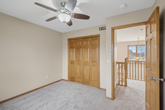 unfurnished bedroom with visible vents, a closet, baseboards, and carpet floors